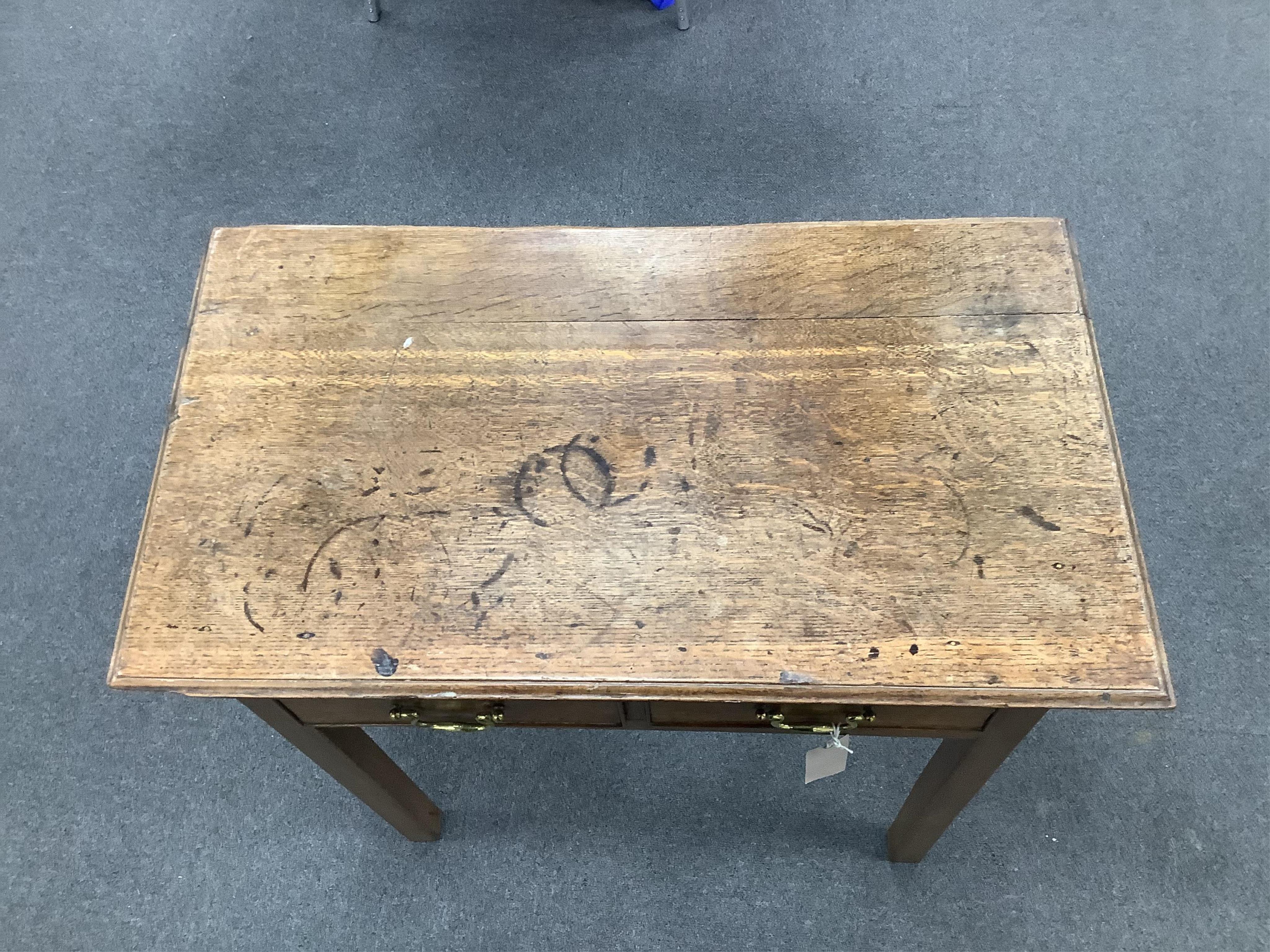 A small 18th century oak two drawer side table, width 69cm, depth 39cm, height 70cm. Condition - poor to fair